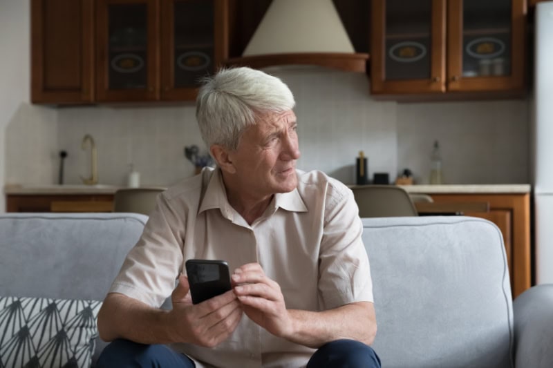 What’s That Smell Coming From My Furnace? Worried senior smartphone user getting bad, concerning news message.