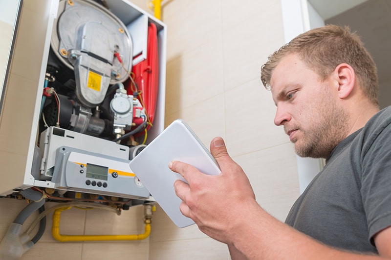 A service tech working on a HVAC unit.