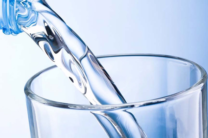 All About Water Softeners Problems—and How to Fix Them. Water being poured into a glass.